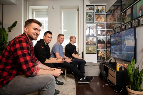 Casper and colleagues playing PlayStation at the office